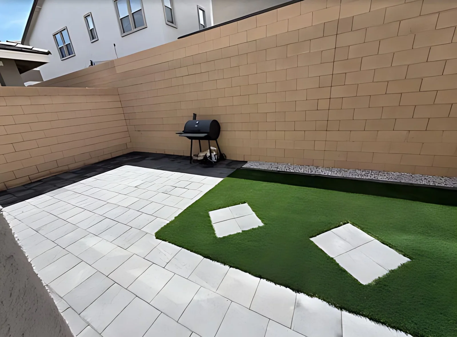 Backyard paver patio with turf inlay